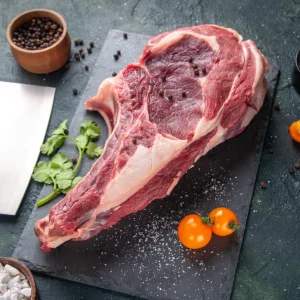 top-view-big-meat-slice-raw-meat-with-pepper-dark-surface